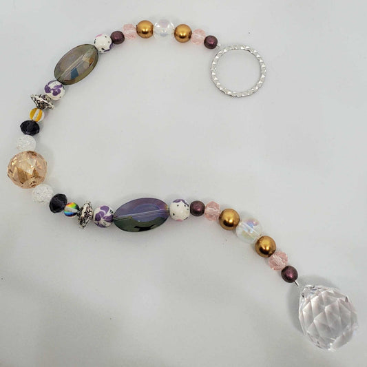 Purple and gold floral crystal suncatcher with teardrop prism and decorative beads