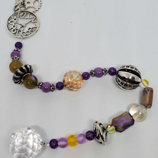 Steampunk Crystal Suncatcher with purple and gold beads, 20mm teardrop prism, and industrial pewter accents