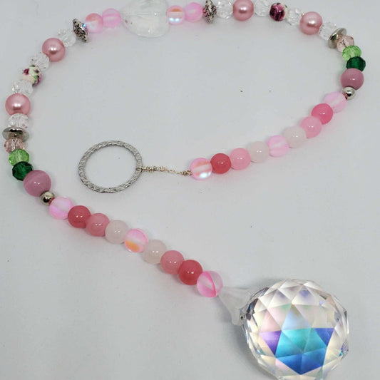 Crystal suncatcher with pink floral beads, teardrop prism crystal, and pewter accents.