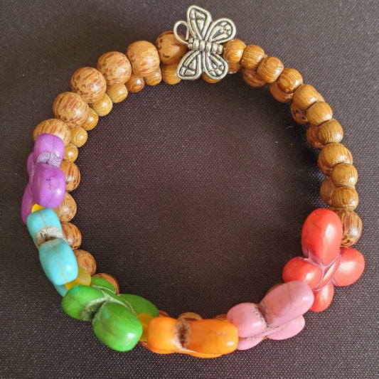 Bohemian bracelet with colorful howlite butterfly beads, natural wood, and sea glass accents on flexible memory wire