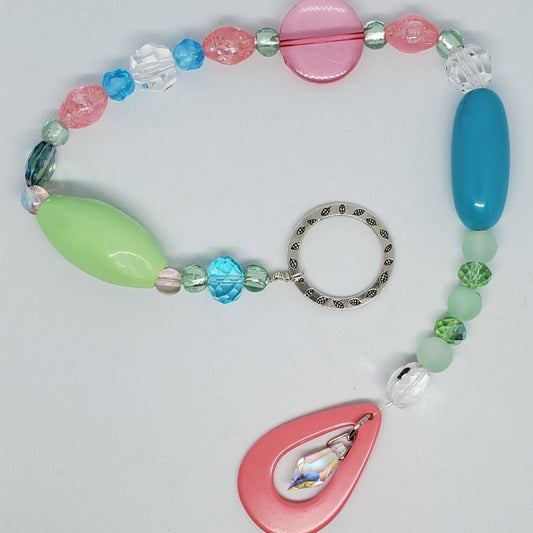 Colorful retro-inspired crystal suncatcher with Lucite, acrylic beads, and glass accents.