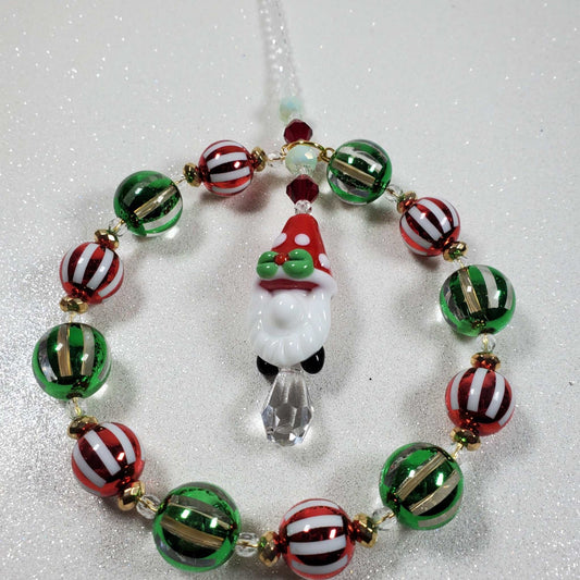 Holiday Ornament featuring a Santa Gnome beaded suncatcher with red, green, and white striped beads and a teardrop prism pendant