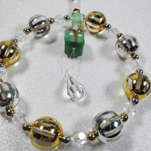 Holiday Ornament beaded suncatcher with glass present bead, gold and silver accents, and teardrop prism hanging decoration