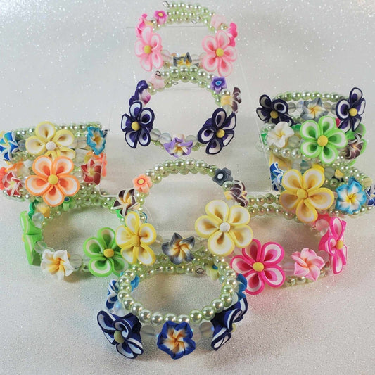 Colorful Floral Jewelry flower garden bracelets for children featuring polymer flower beads, acrylic pearls, and sparkling crystals on flexible memory wire.