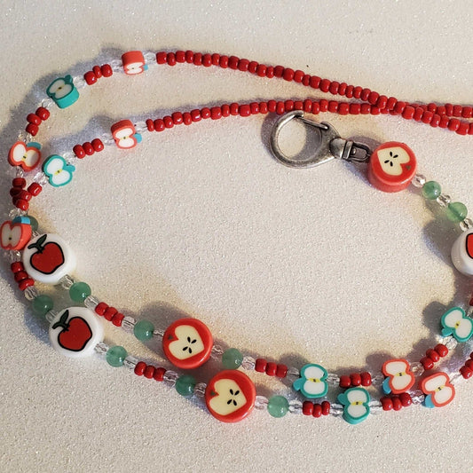 Handcrafted apple-themed lanyard with red, green, and apple-shaped beads and a metal clasp for keys or ID.