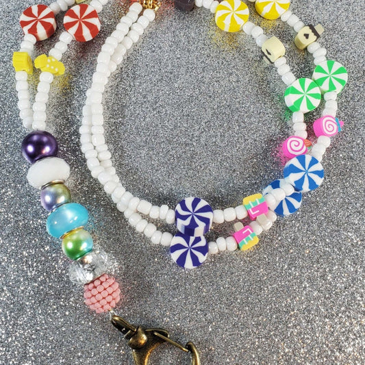 Colorful Sweet Shoppe lanyard with polymer clay candy and pastry beads, Czech glass seed beads, and brass dog clip