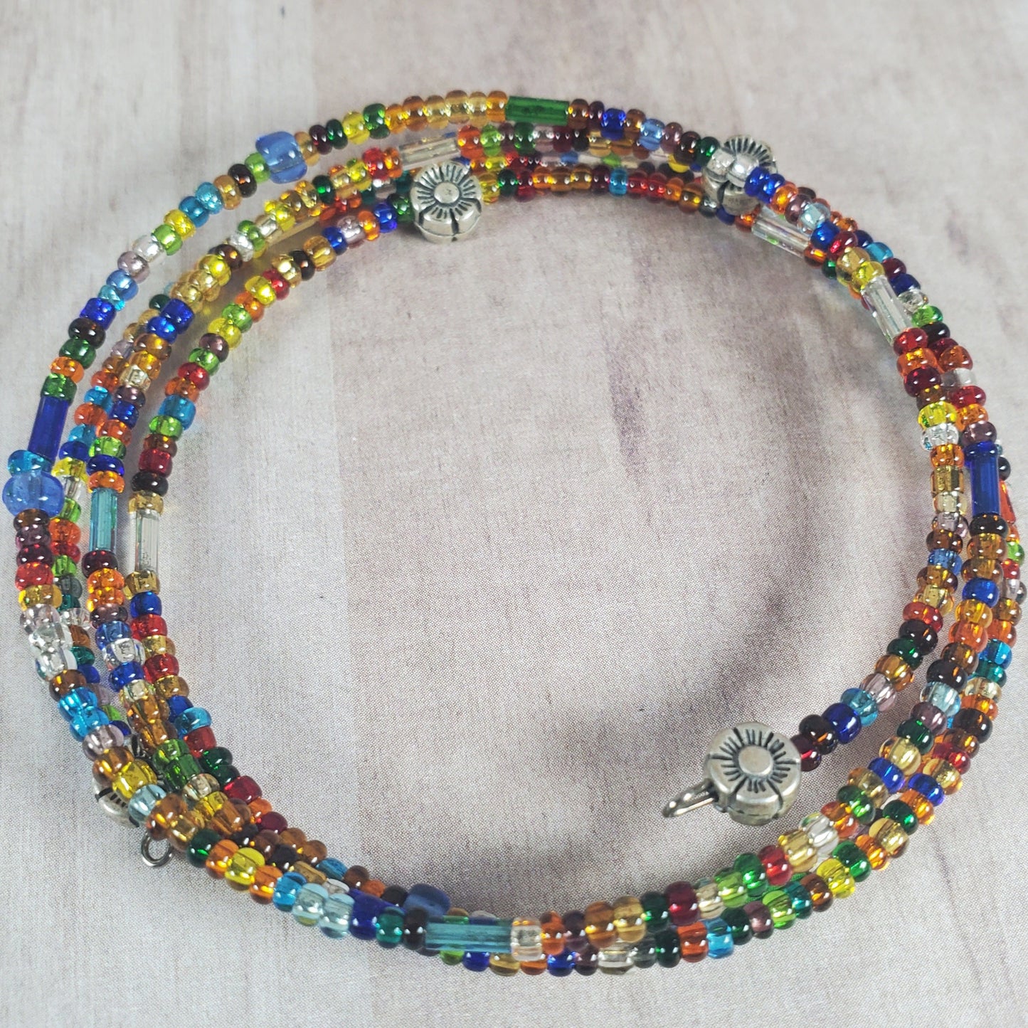 Multicolored beaded necklace on a light gray background