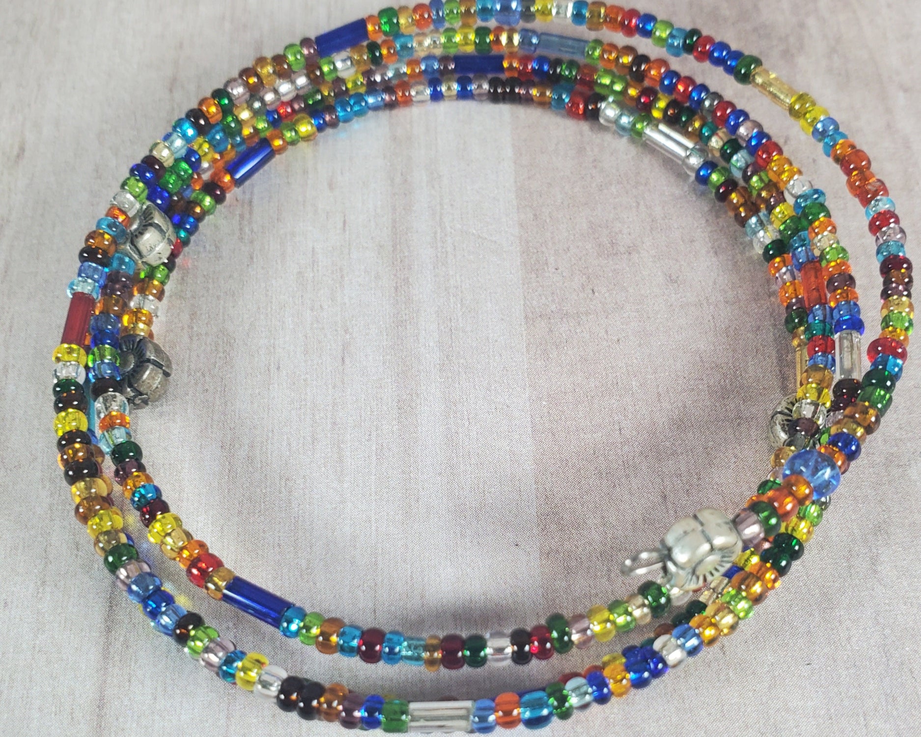 Colorful beaded necklace on a light gray background