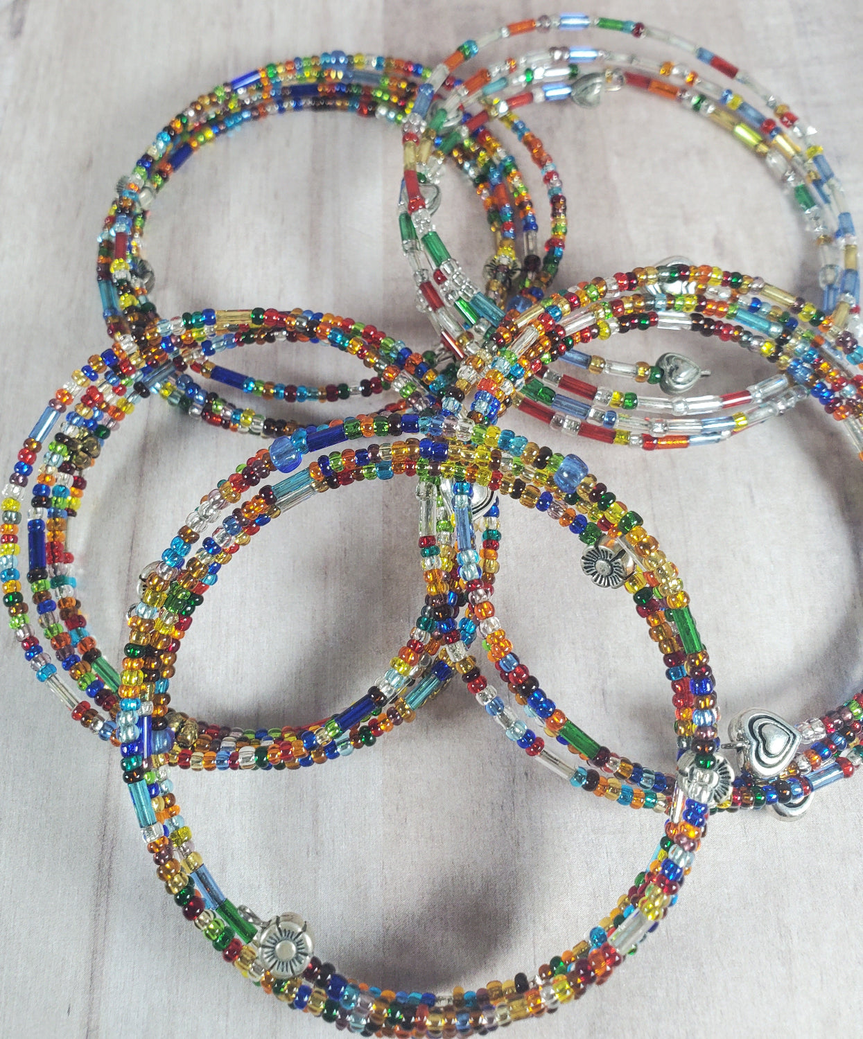 Colorful beaded bracelets on a light background