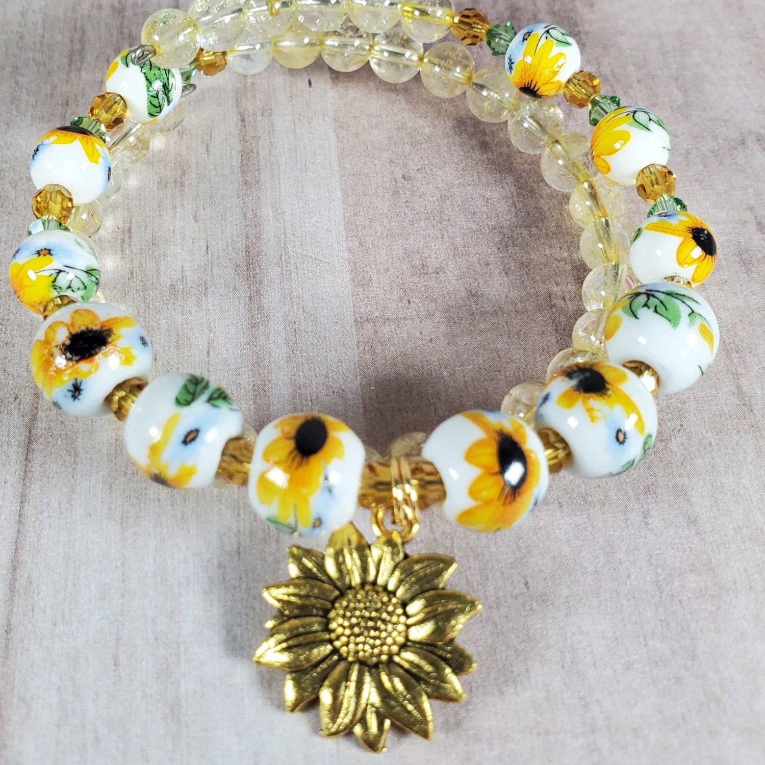 Floral bracelet with porcelain sunflower beads, citrine gemstones, Austrian crystals, and brass sunflower charm on adjustable memory wire