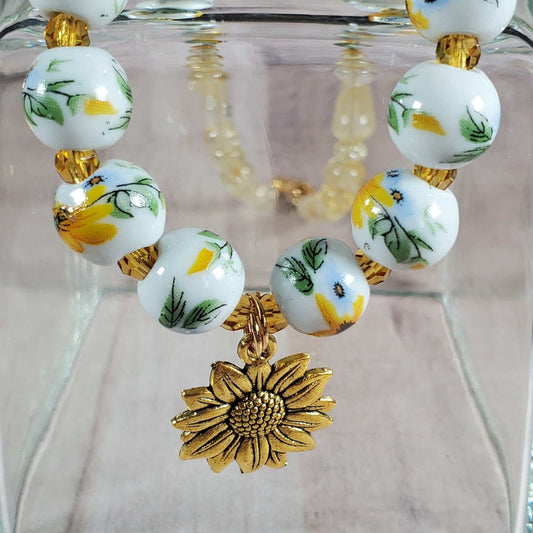 Floral necklace with porcelain sunflower beads and brass sunflower charm