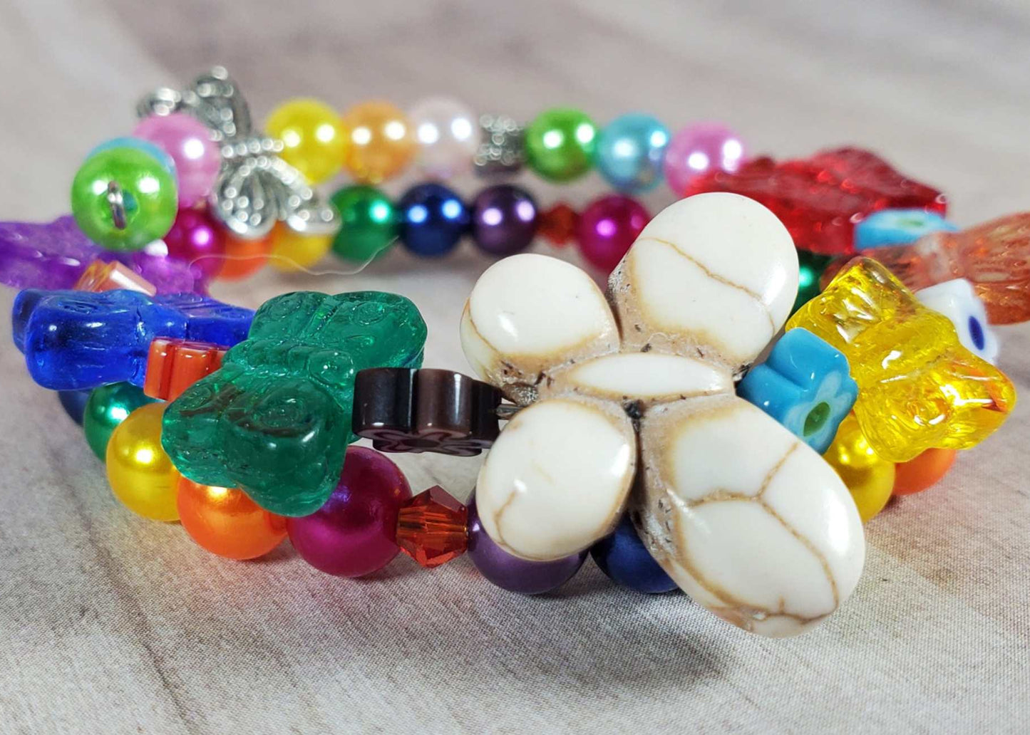 Colorful butterfly bracelet for children with beads and acrylic pearls on flexible memory wire