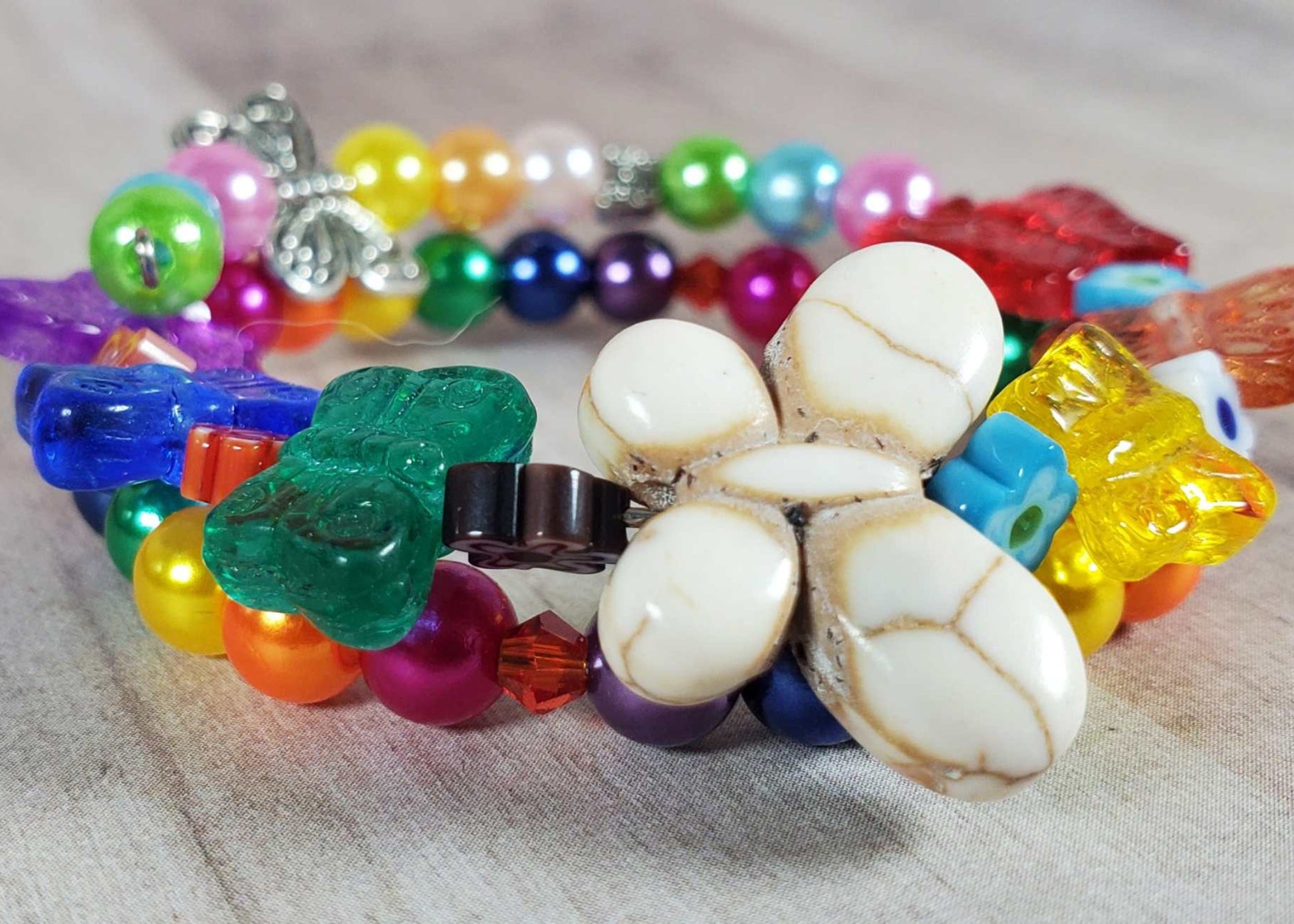 Colorful butterfly bracelet for children with beads and acrylic pearls on flexible memory wire