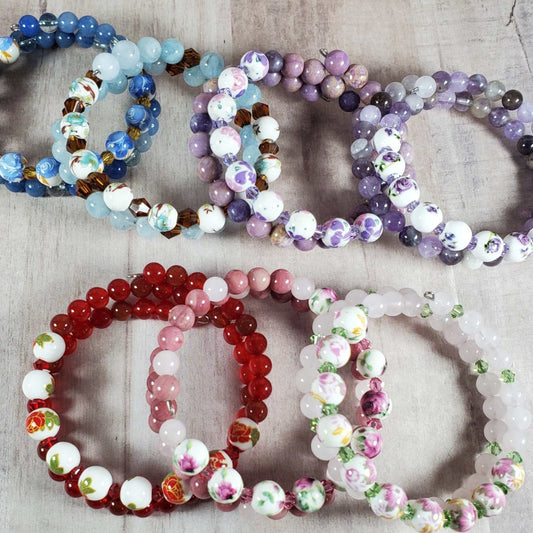 Floral bracelet set with gemstone and porcelain floral beads in various colors on flexible memory wire.