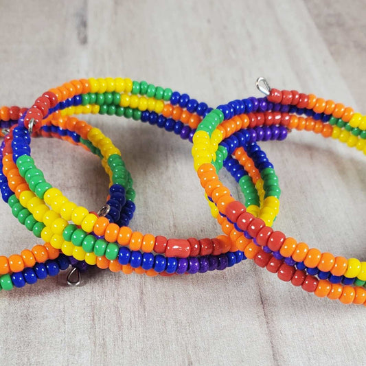 Child-sized cuff bracelet with colorful rainbow seed beads and flexible memory wire for a comfortable fit