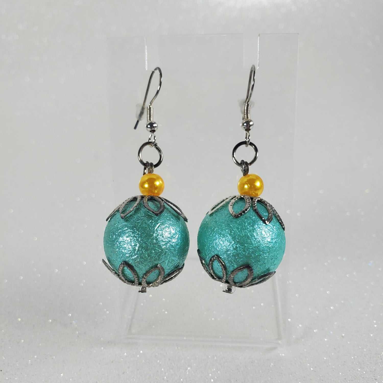 Turquoise bead earrings with yellow beads on a white background