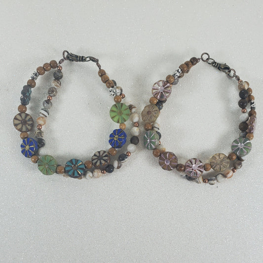 Two beaded floral bracelets on a light gray background