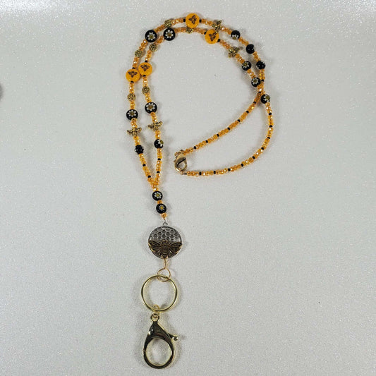 Bee-themed lanyard with yellow and black beads, Czech glass, Austrian crystal, brass accents, pewter honeycomb pendant, and silvertone clip