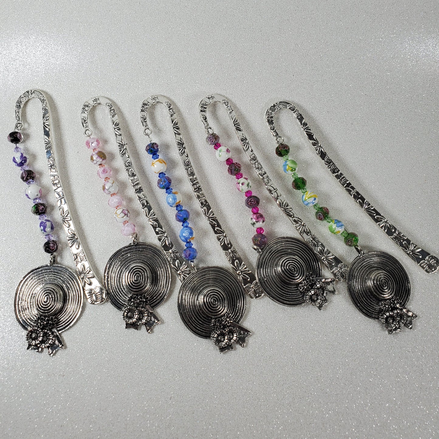 Set of decorative bookmarks with beads on a gray background