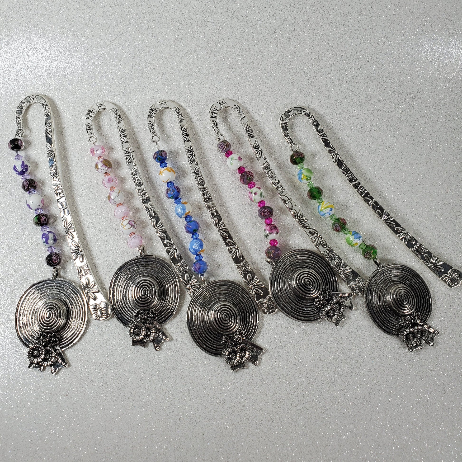 Set of decorative bookmarks with beads on a gray background