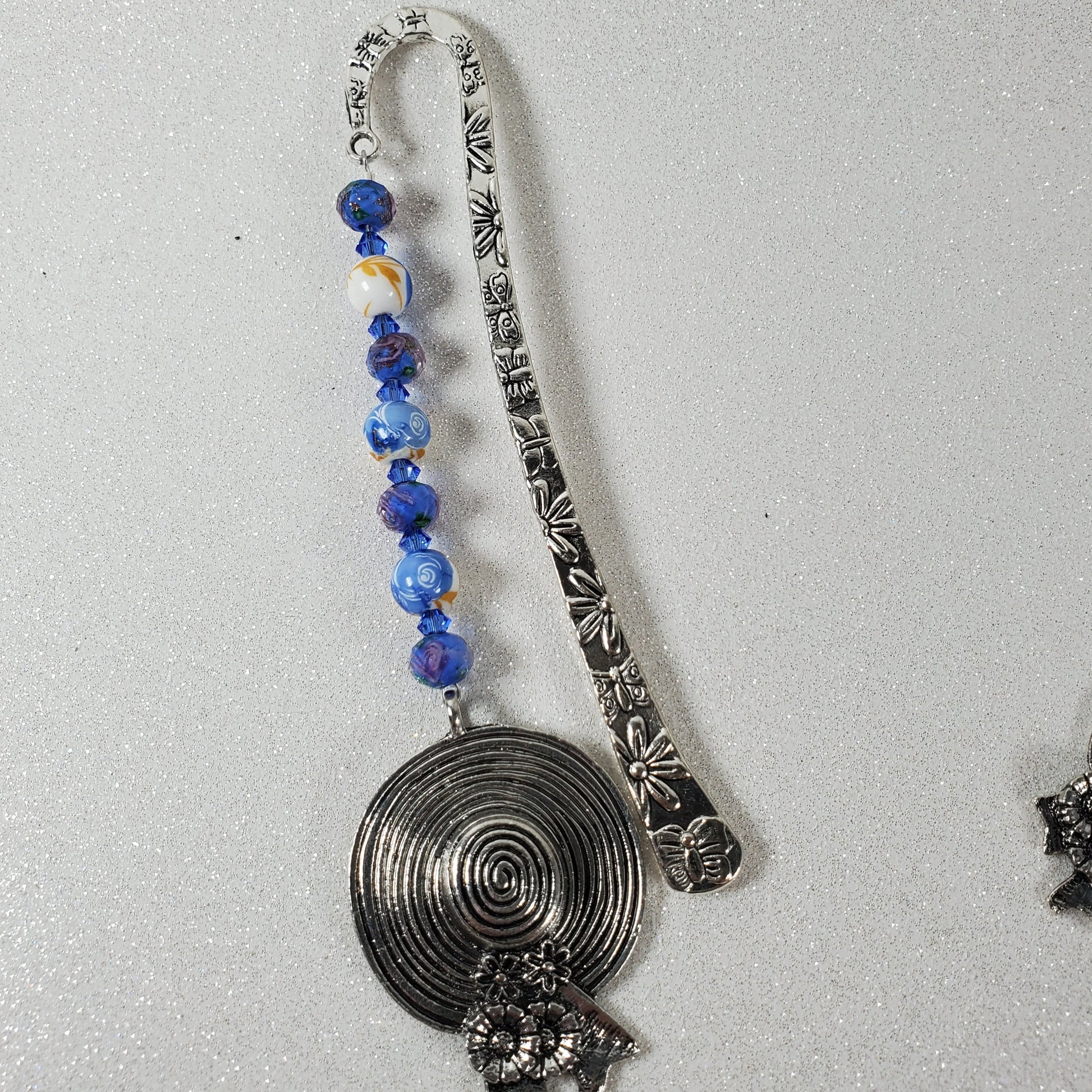 Decorative bookmark with blue beads on a white background