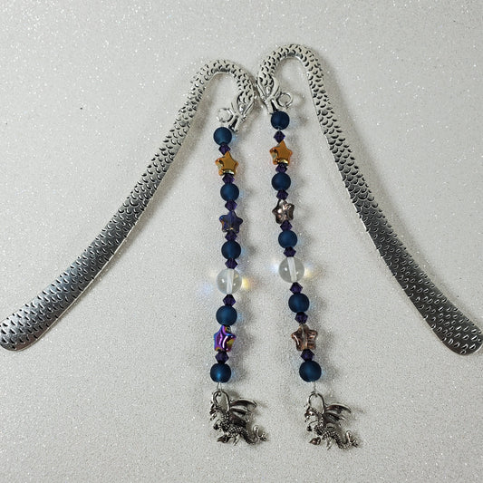 Bookmark with beaded chain and silver pendant on a light gray background