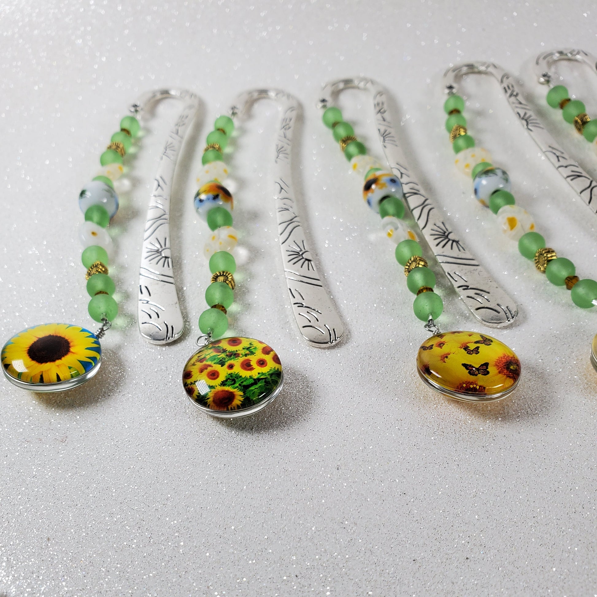 Close-up of decorative bookmarks with colorful embellishments on a light background