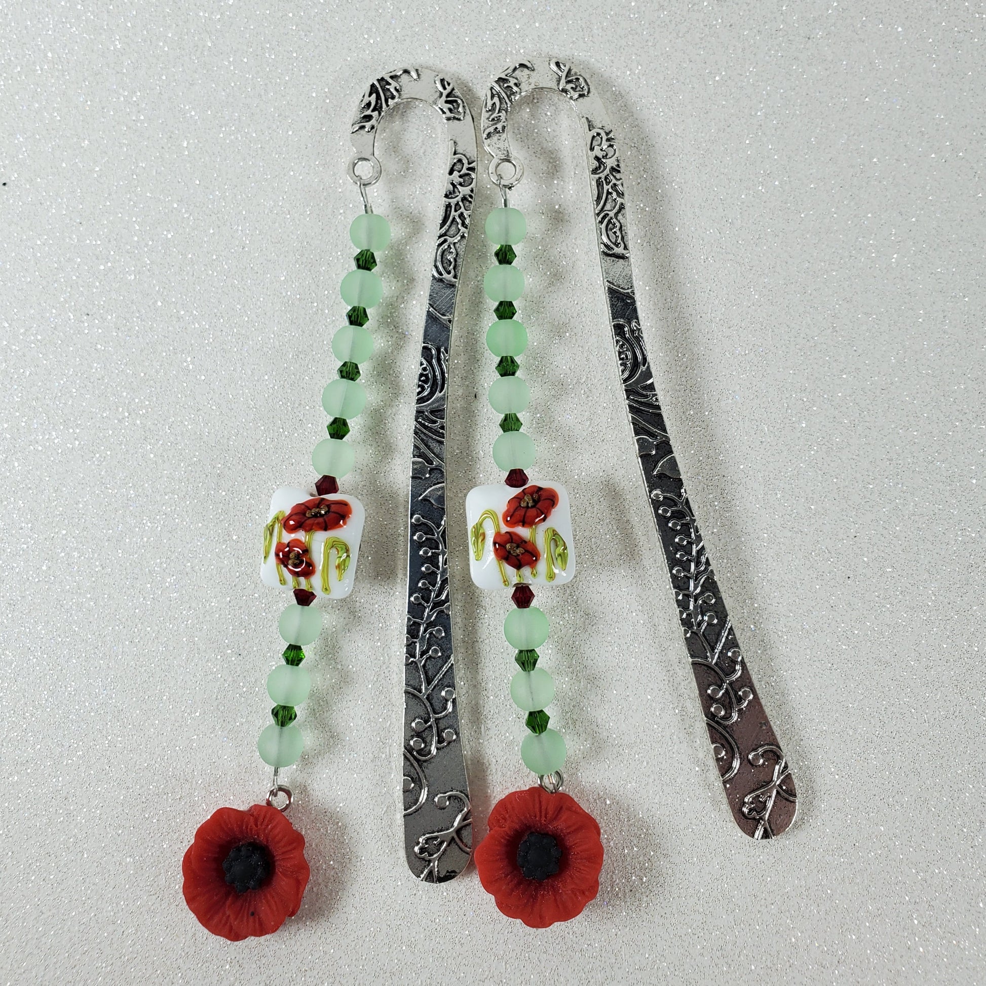 Two decorative bookmarks with floral designs on a light gray background