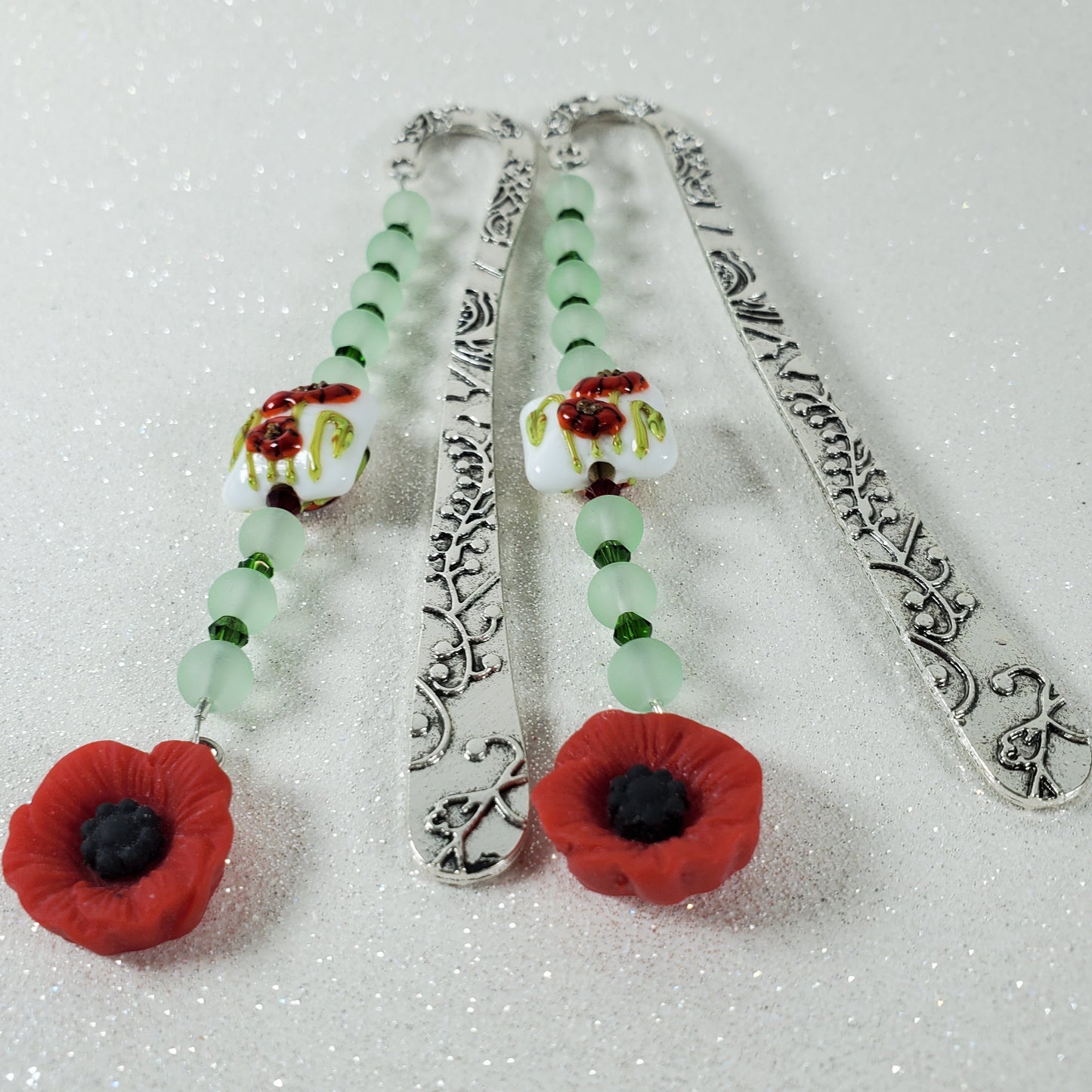 Decorative bookmark with floral designs on a textured white background