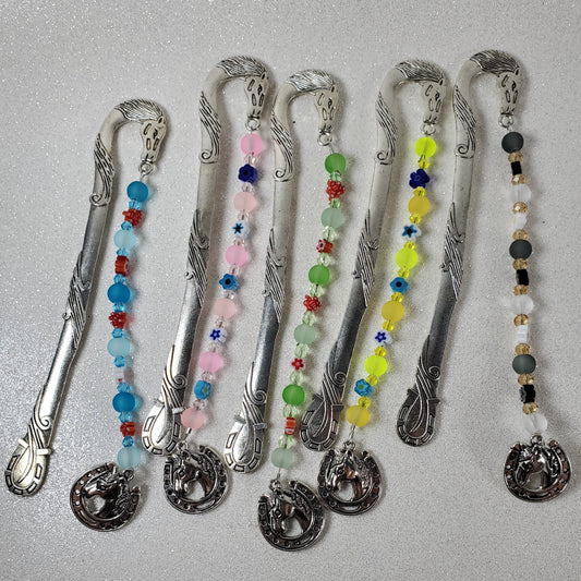 Decorative bookmarks with colorful beads on a gray surface