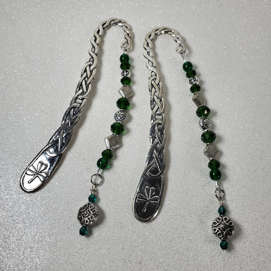 Silver bookmark with green beads on a gray background