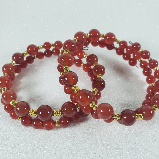 Red beaded necklace on a white background