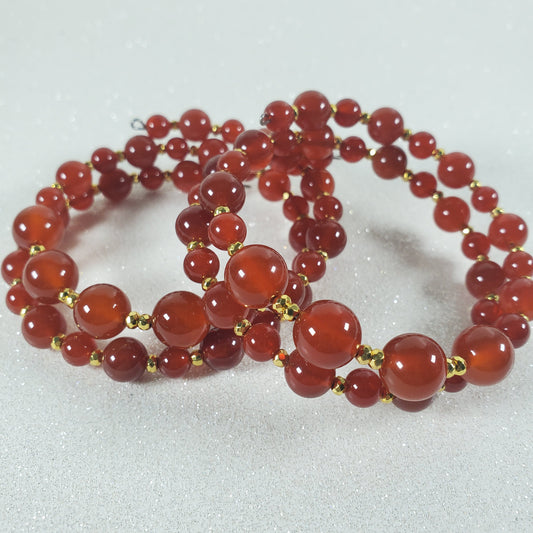 Red beaded necklace on a light gray background