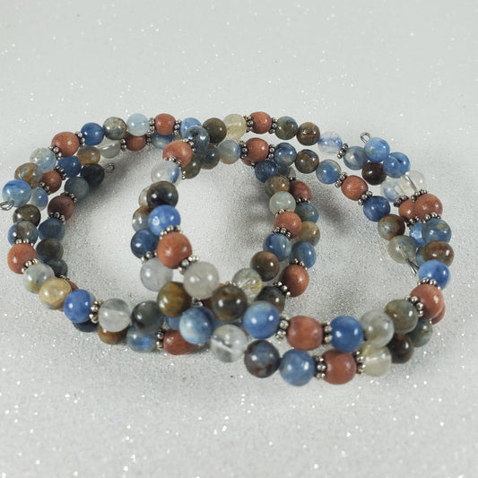 Multicolored beaded bracelet on a textured gray background
