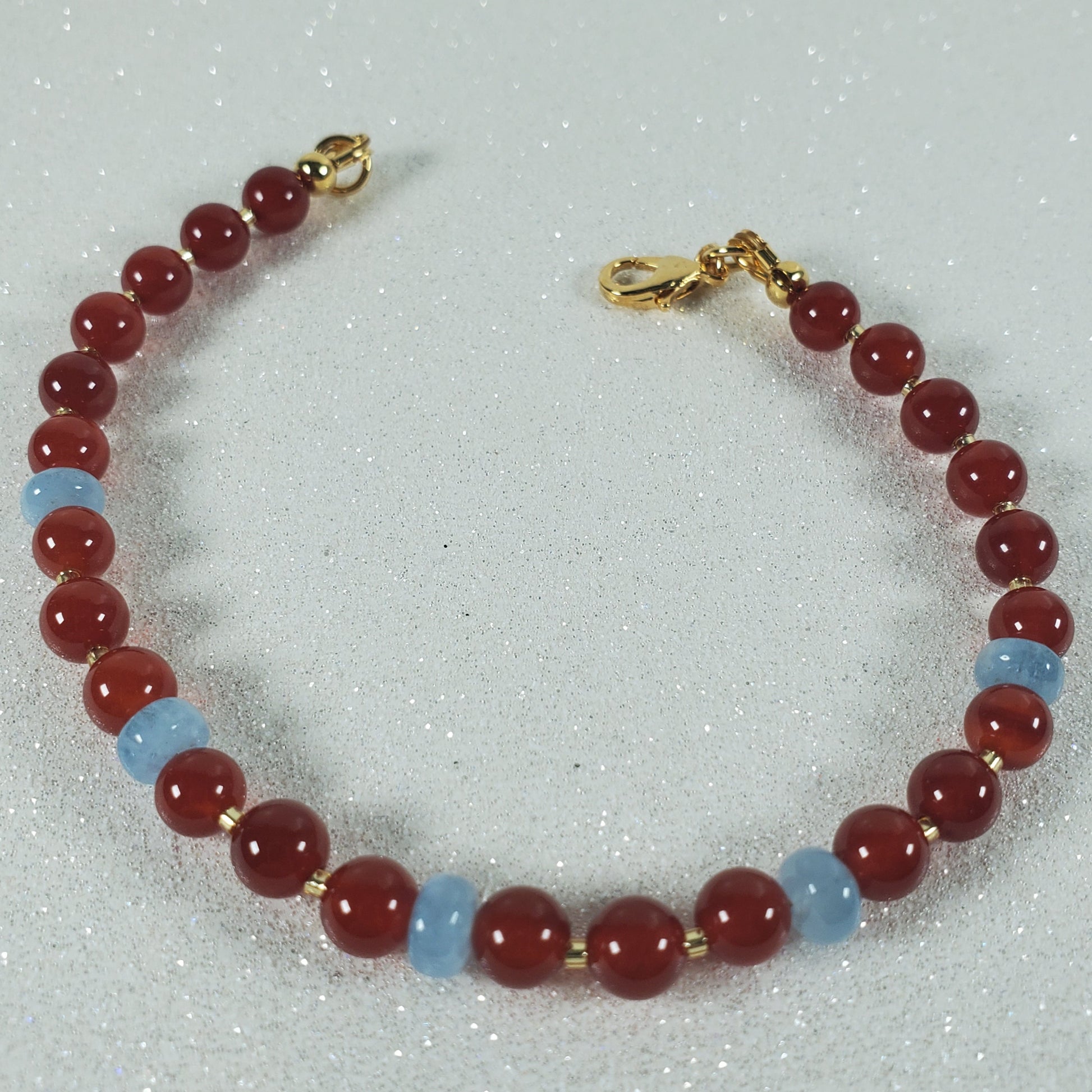 Bracelet with red and blue beads on a light gray background