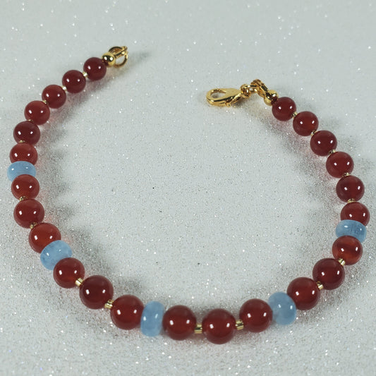 Bracelet with red and blue beads on a light gray background