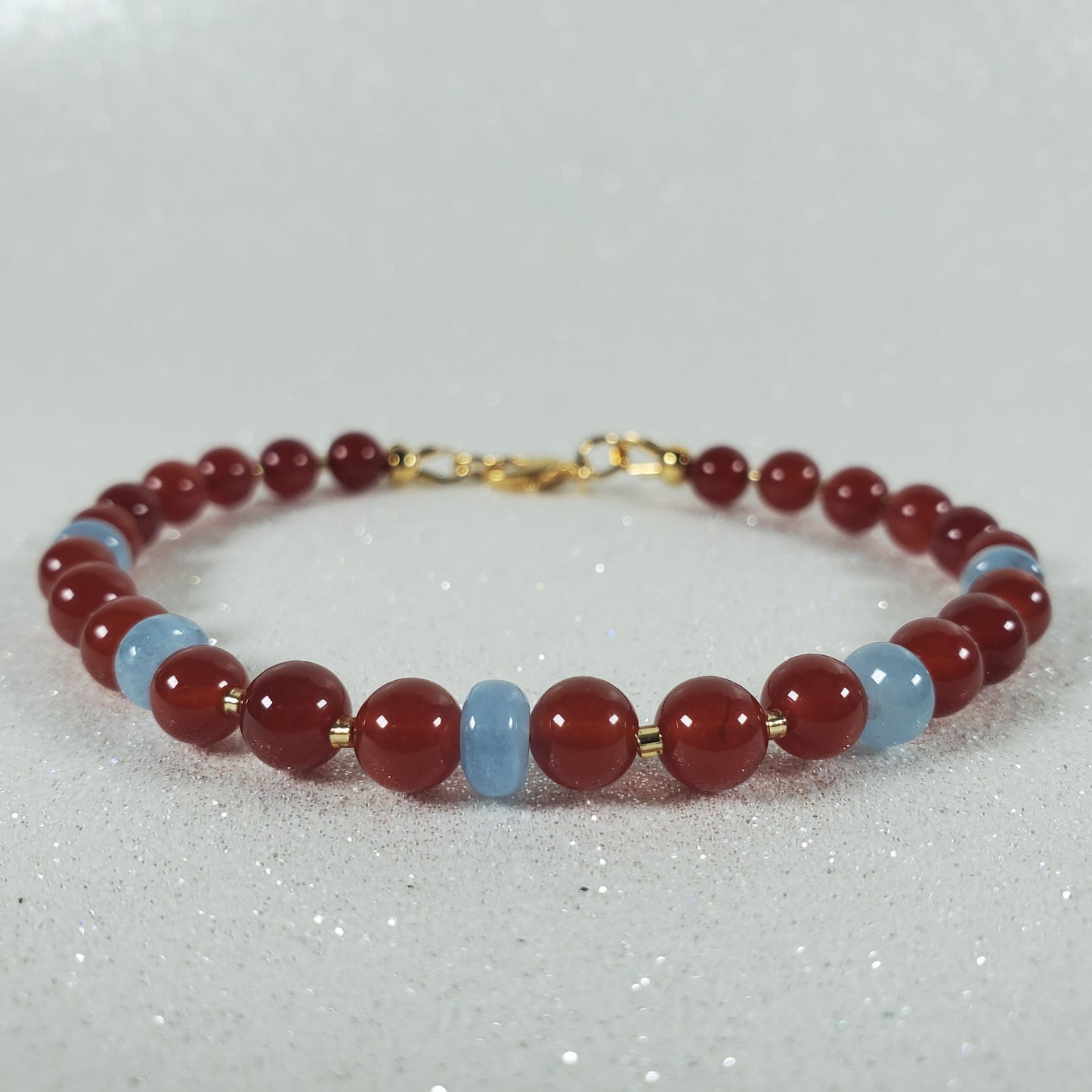 Beaded bracelet with red and blue beads on a white background