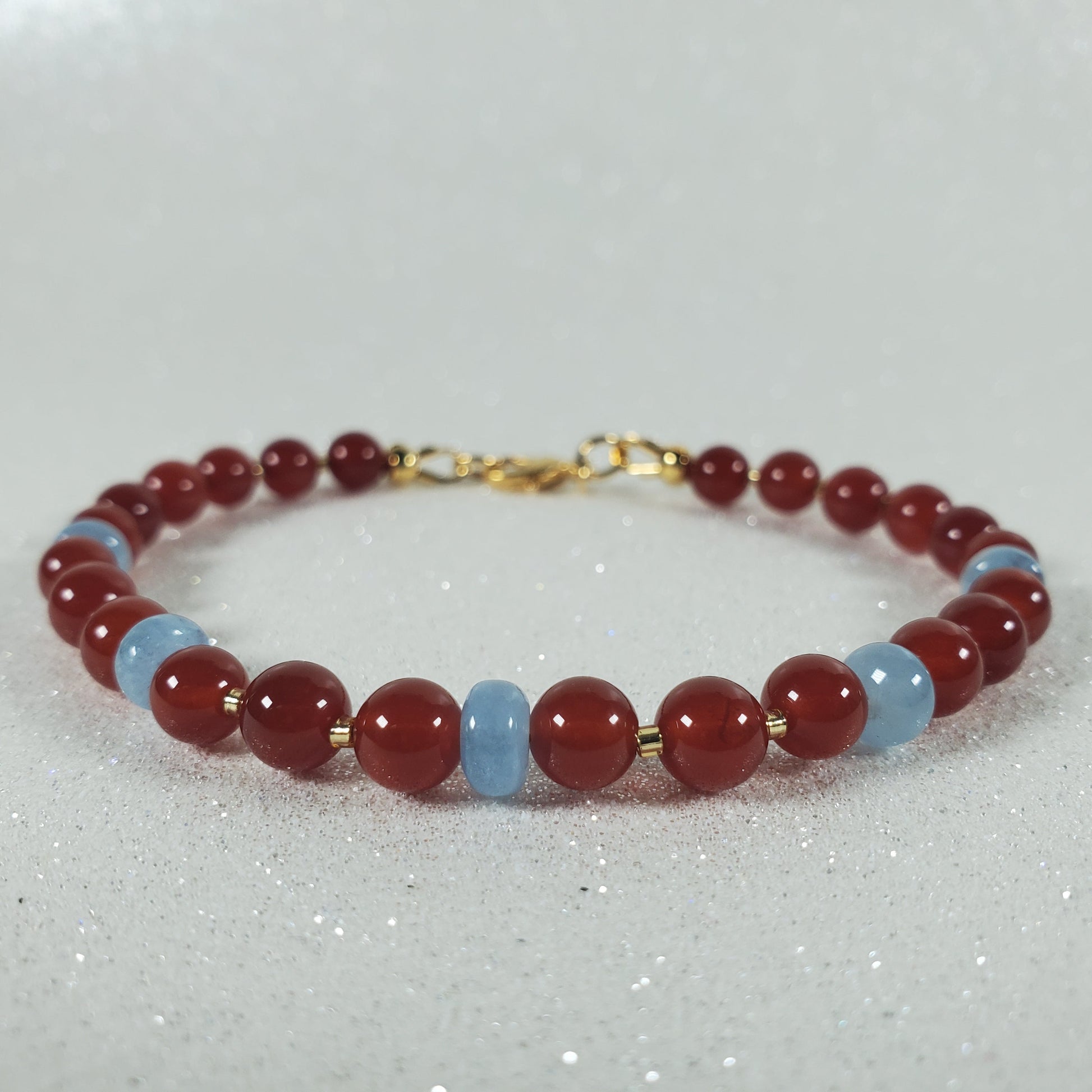 Beaded bracelet with red and blue beads on a white background