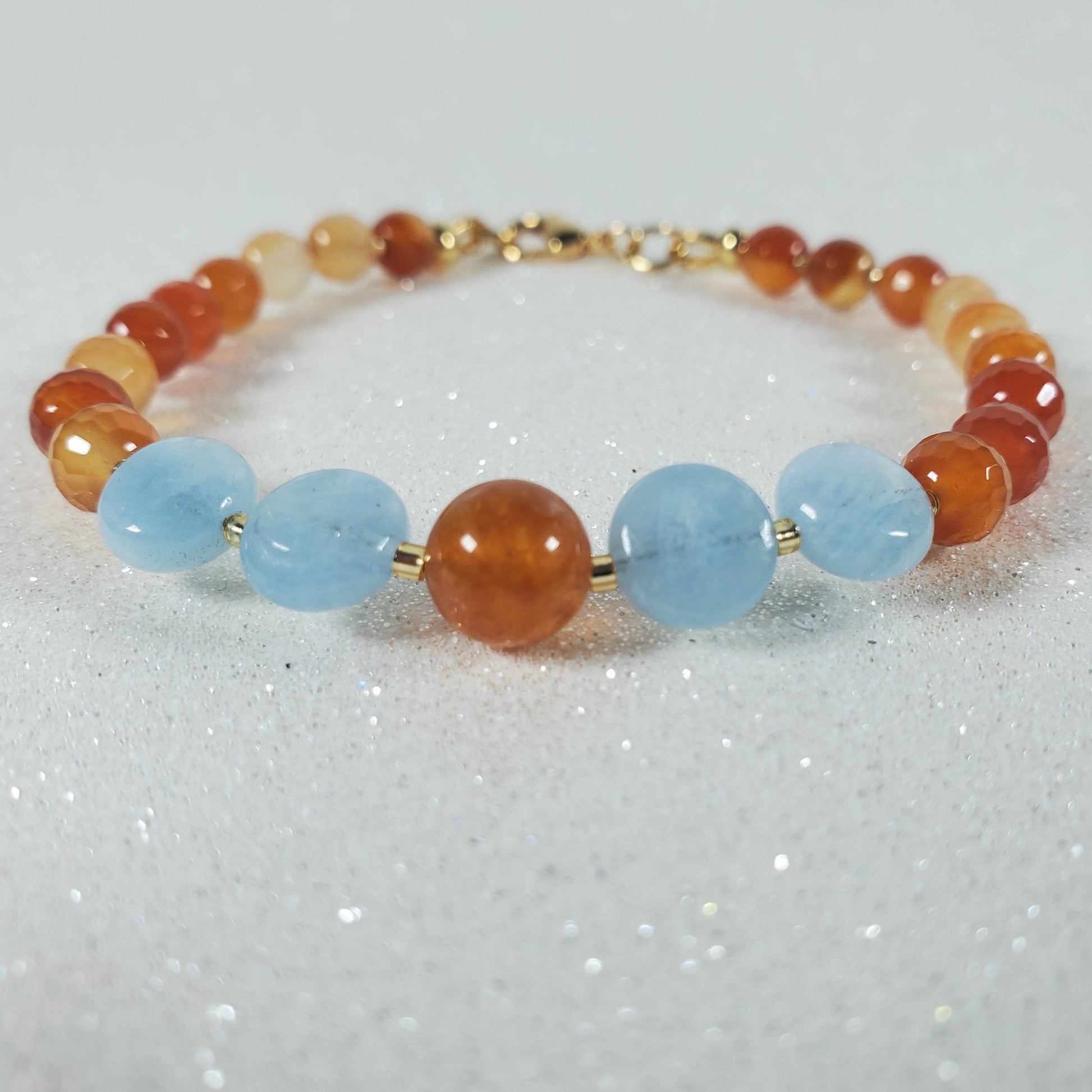 Bracelet with multicolored beads on a glittery white background