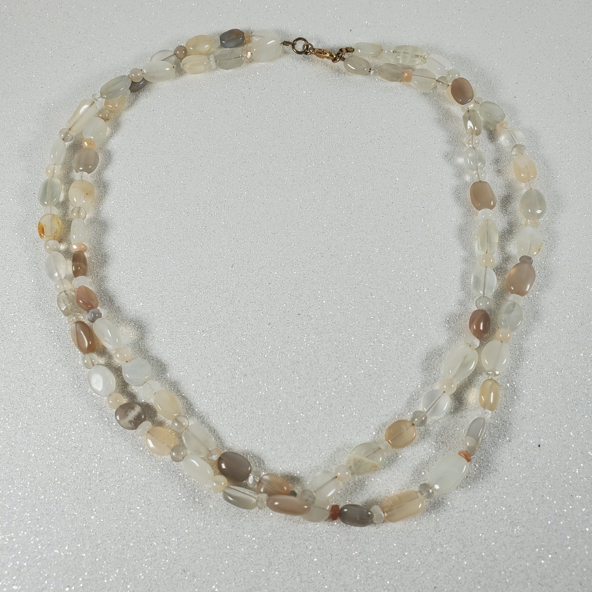 Necklace with multicolored beads on a light gray background