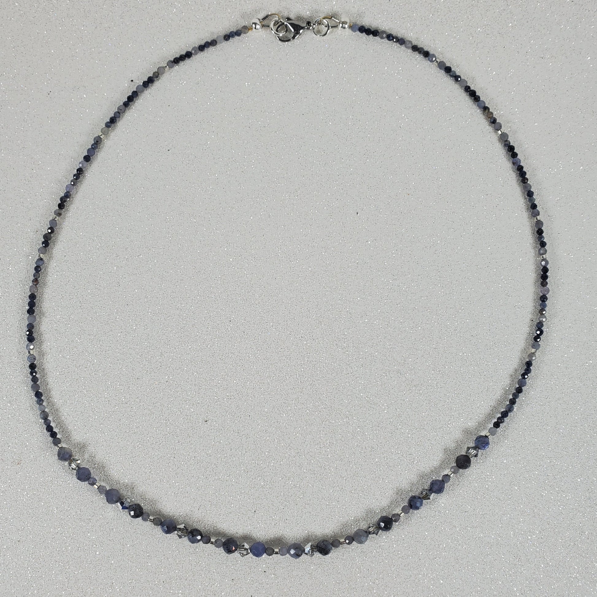 Necklace with blue beads on a light gray background