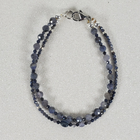 Blue beaded bracelet on a light gray background