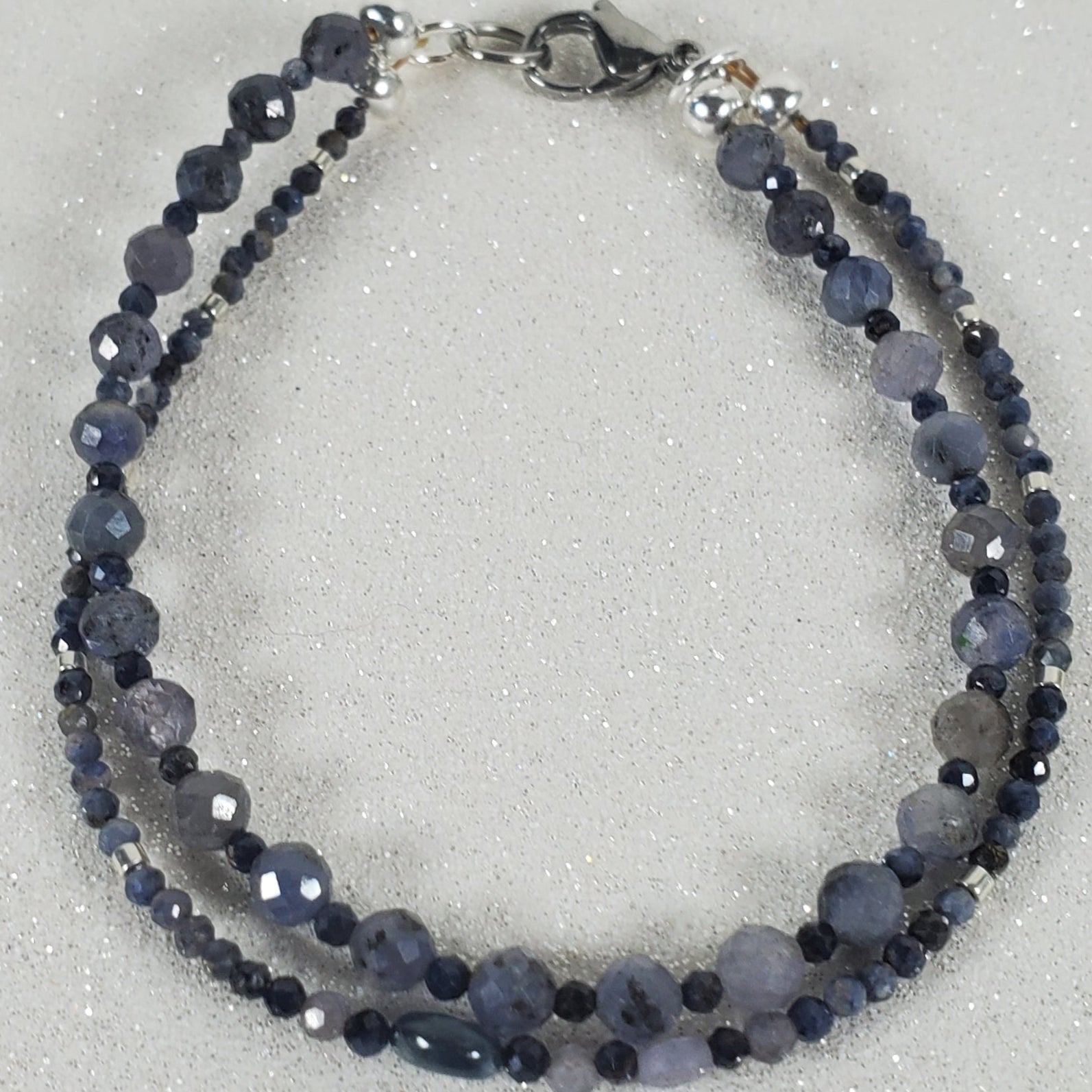 Blue beaded bracelet on a light gray background
