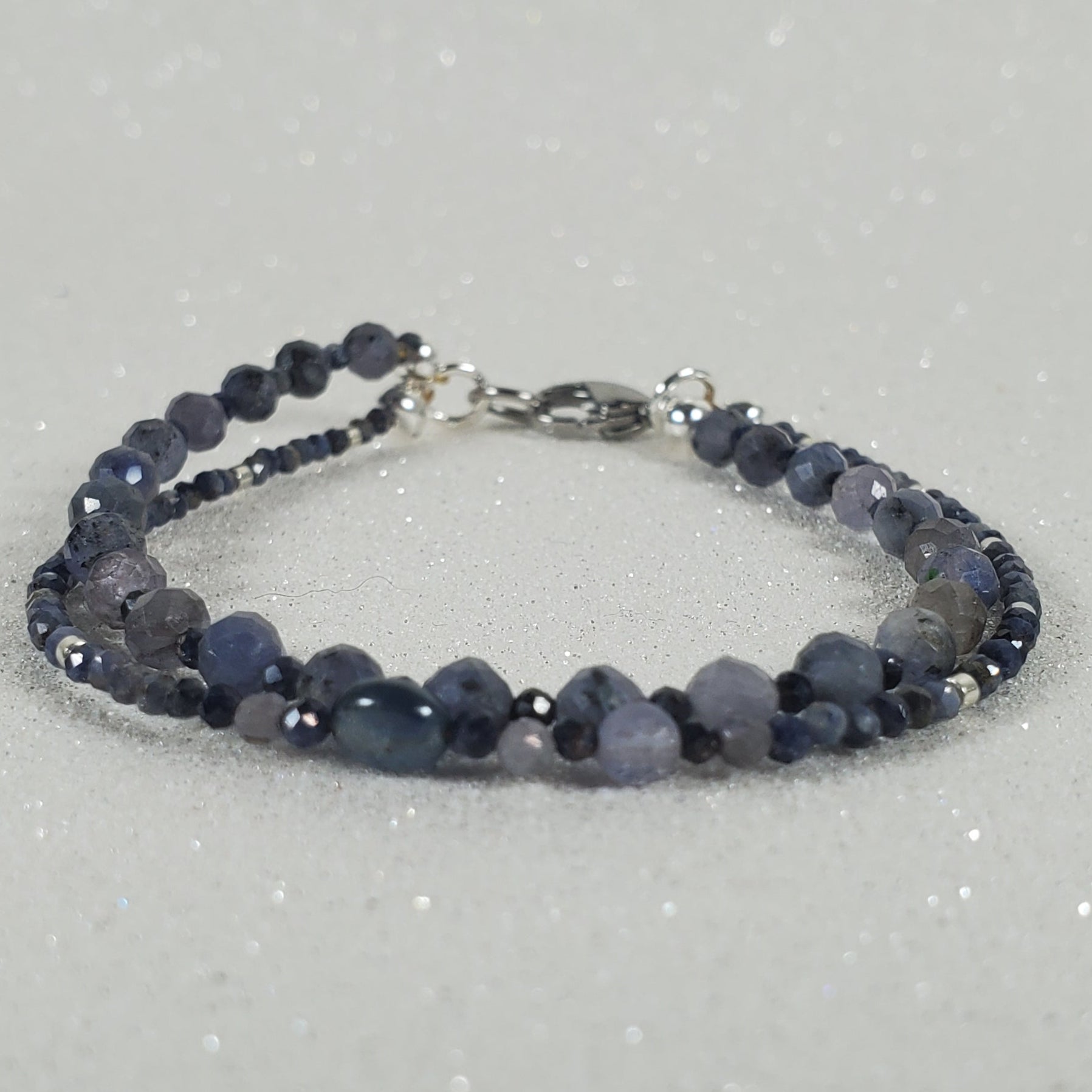 Beaded bracelet on a gray glittery background