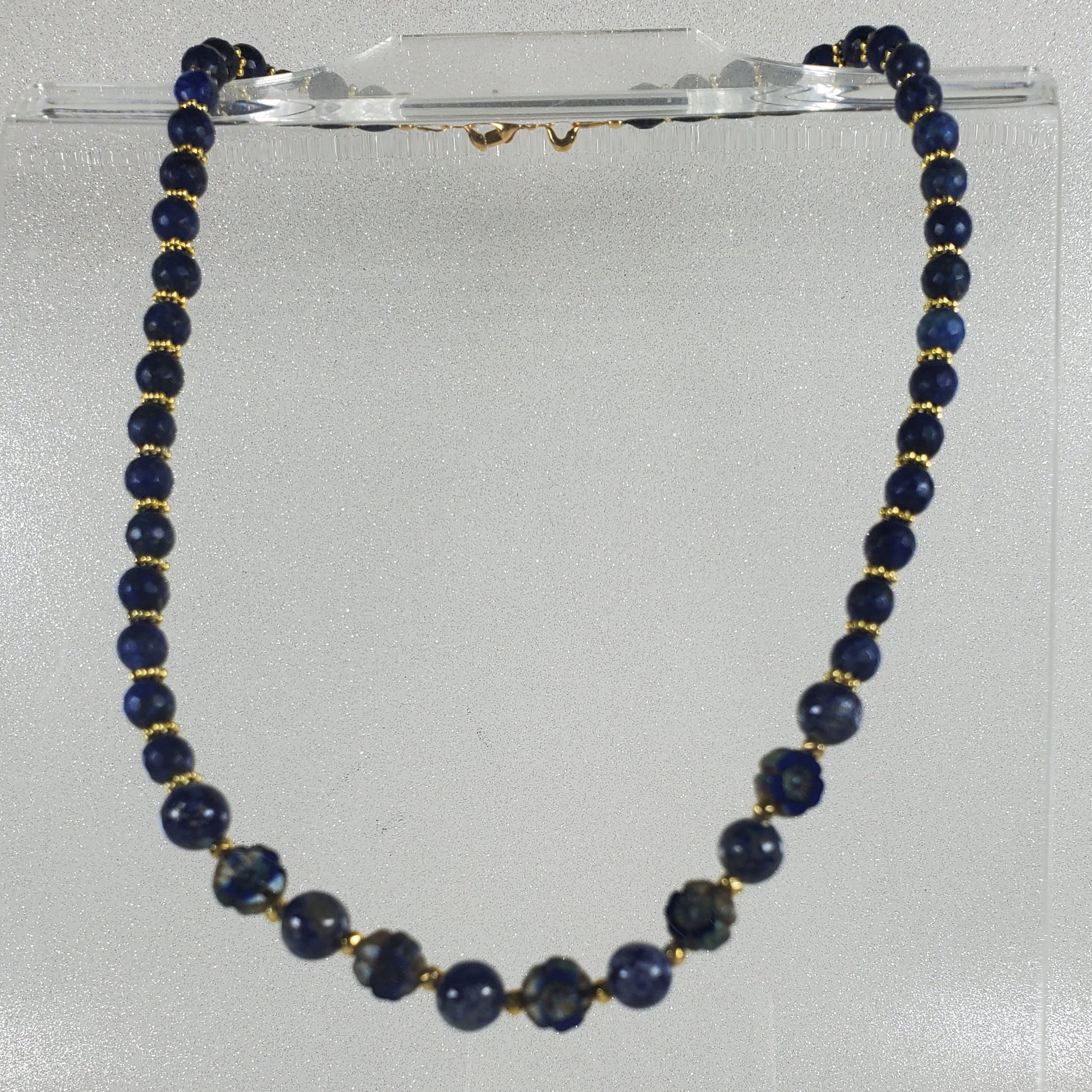 Necklace with blue beads on a white background