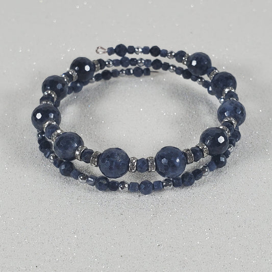 Blue beaded bracelet on a gray background