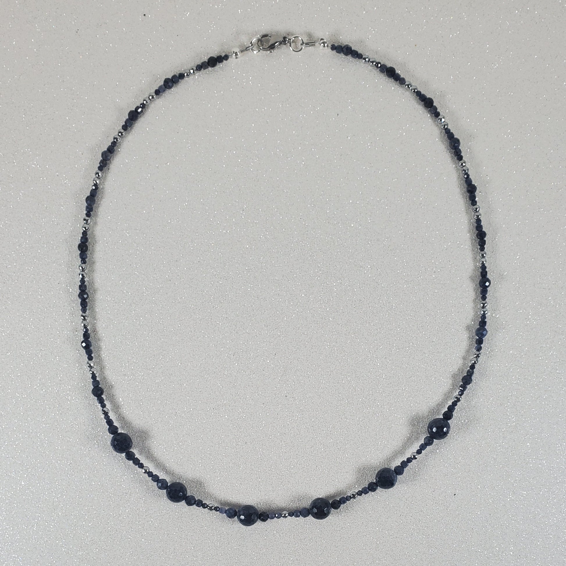 Necklace with blue beads on a white background