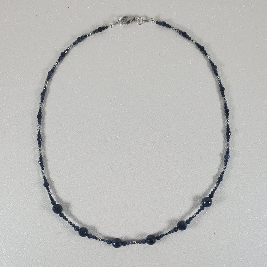 Necklace with blue beads on a white background