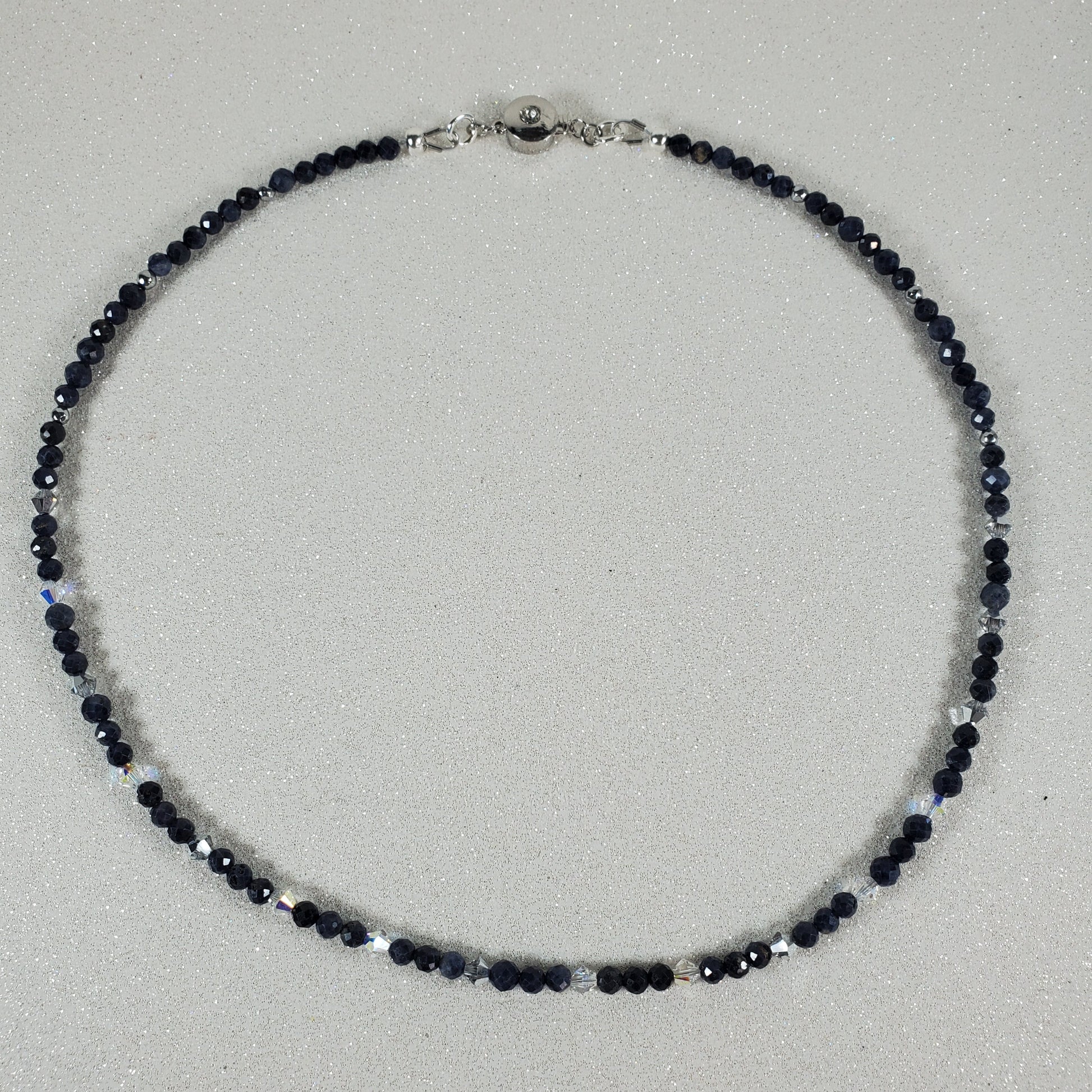 Necklace with Sapphire beads on a light gray background