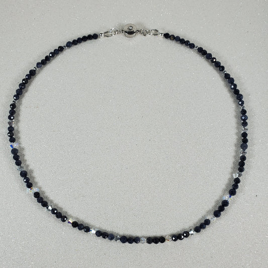 Necklace with Sapphire beads on a light gray background